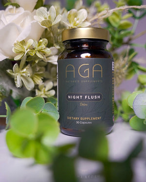 Supplement bottle labeled 'AGA Night Flush' with flowers in the background